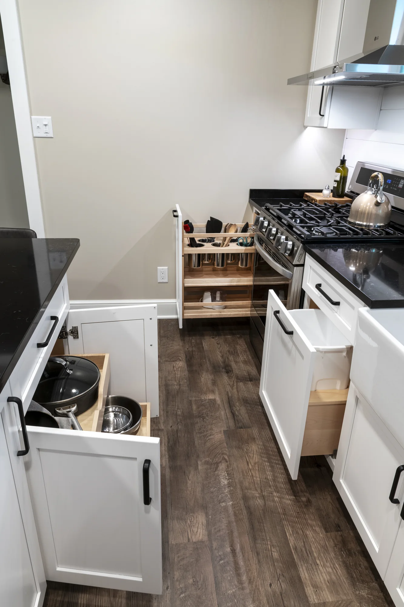 Open base-cabinet storage and pull-outs along the range wall
