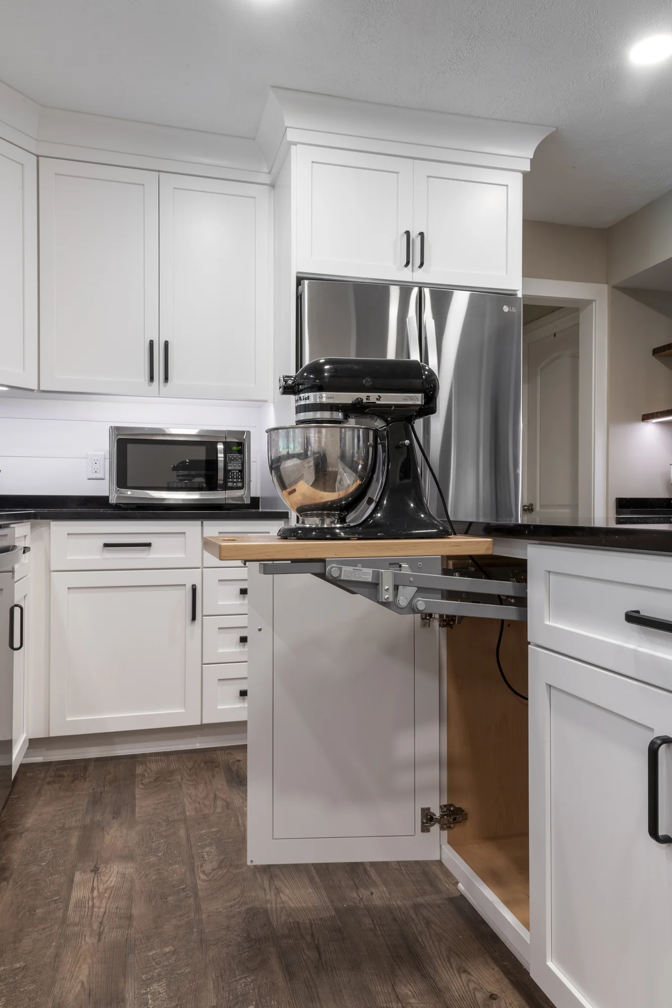 Lift-up mixer storage inside a base cabinet
